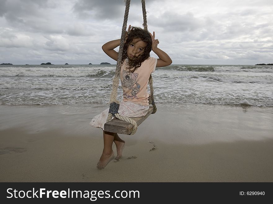 Girl on swing at the sea