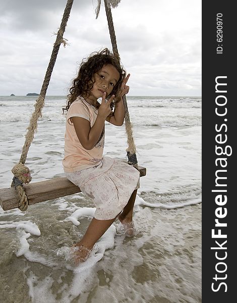 Girl On Swing At The Sea