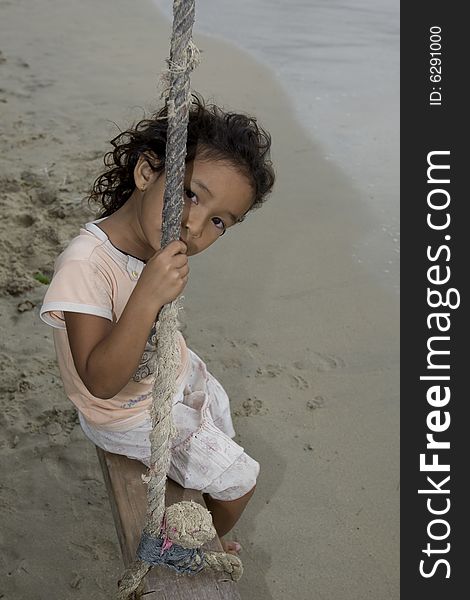 Girl on swing at the sea