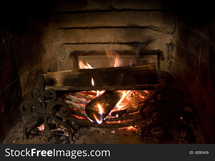 Old Fireplace And A Fire