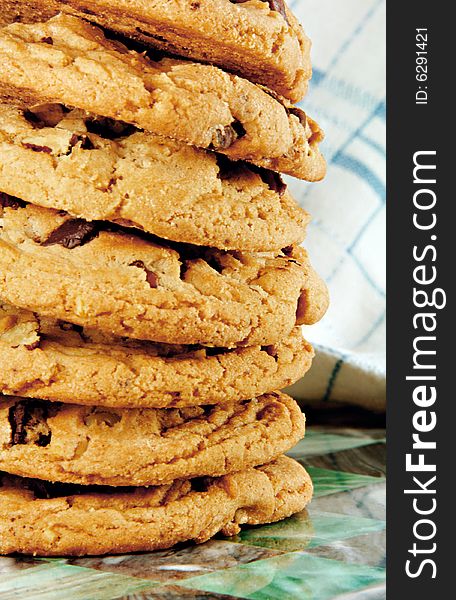 Tall stack of chocolate chip cookies fresh from the oven.