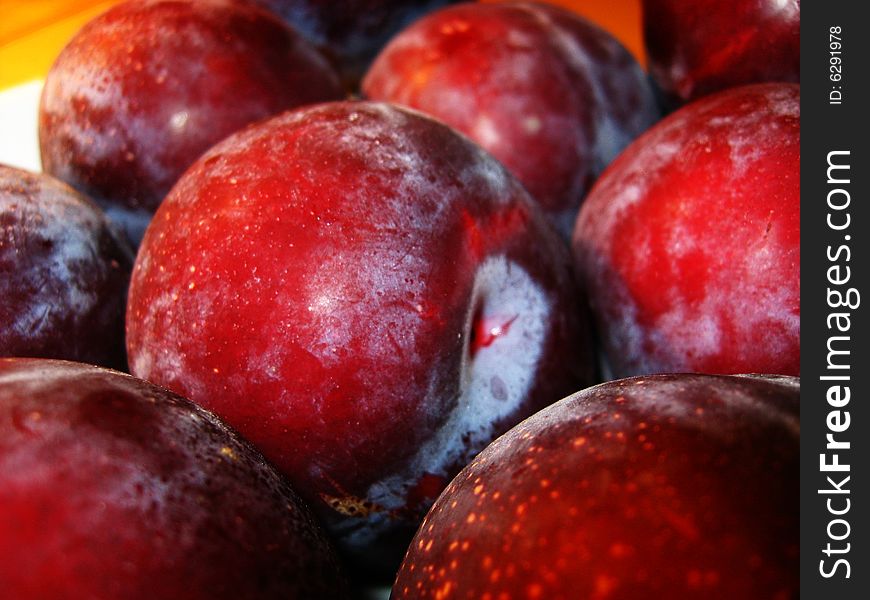A close up of plums in a fruit market. A close up of plums in a fruit market