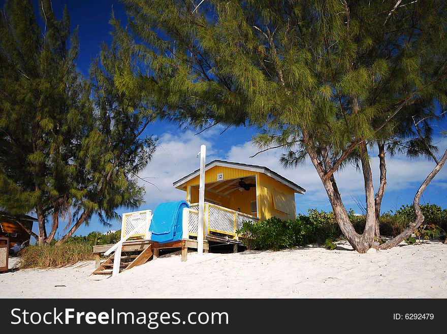 A yellow hut on a beach