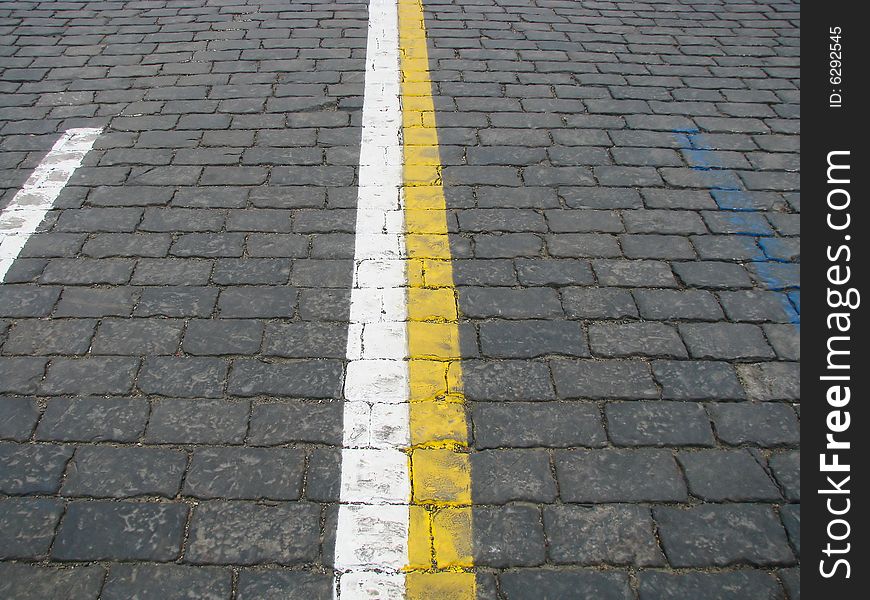 Stone blocks with color lines of a road marking. Stone blocks with color lines of a road marking