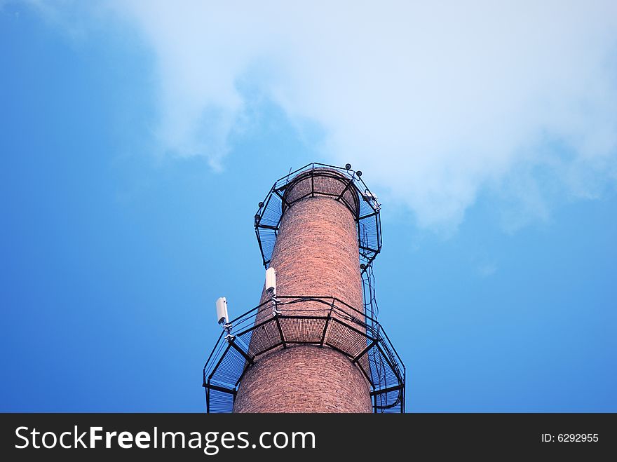 Urban chimney-stalk on a background cloudy sky. Urban chimney-stalk on a background cloudy sky