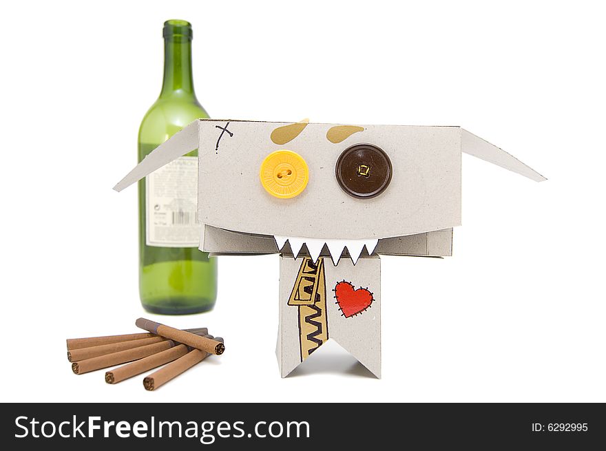 Wine bottle, cigarettes and freaky cardboard toy. Wine bottle, cigarettes and freaky cardboard toy