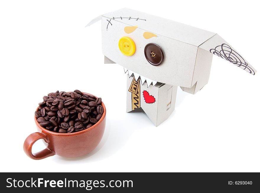 Cardboard toy with expressive face and cup of coffee beans isolated. Cardboard toy with expressive face and cup of coffee beans isolated