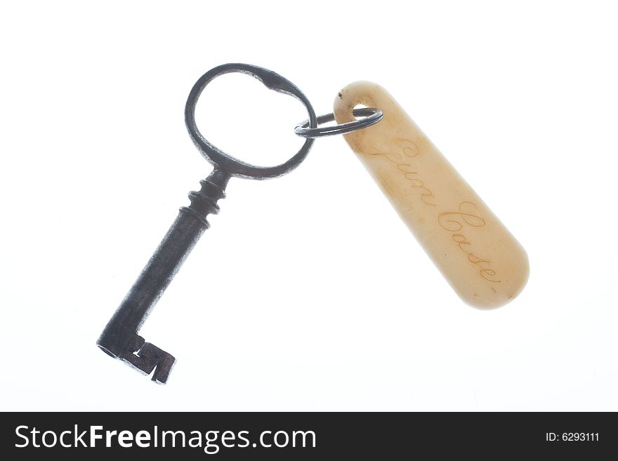 old antique key with badge on white