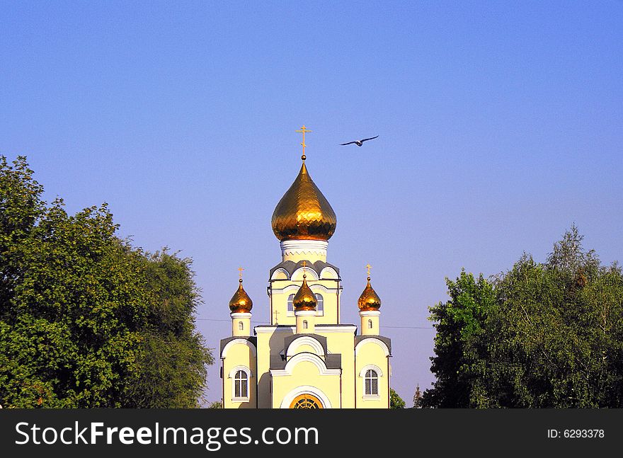 City park, Russian patriarchy, church of sainted Vladimir, sainted place, christian faith, orthodox community, blue sky above gold domes, gold crosses,