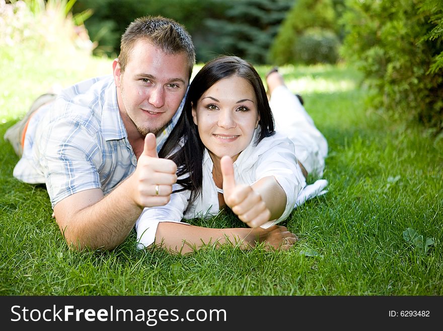 Casual couple lying together on grass. Casual couple lying together on grass