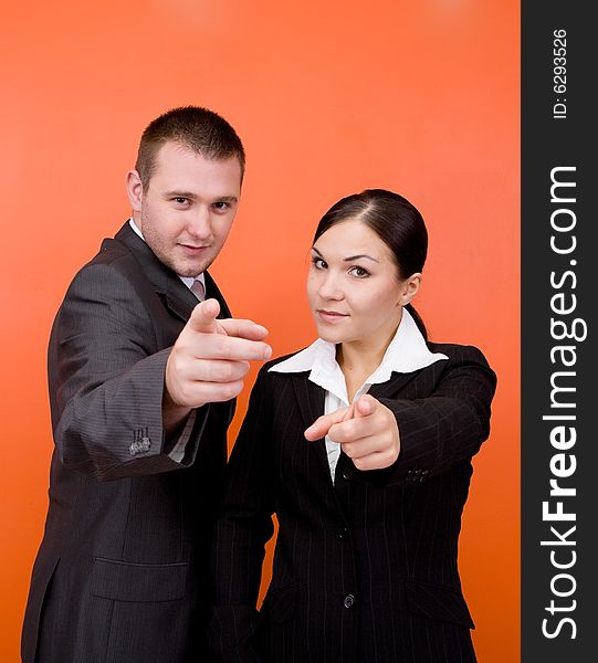 Woman and man in business team standing on orange background