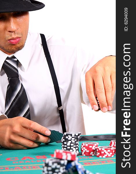 Young man playing poker. He is holding cards and chips in his hands. Isolated over white background. Young man playing poker. He is holding cards and chips in his hands. Isolated over white background.