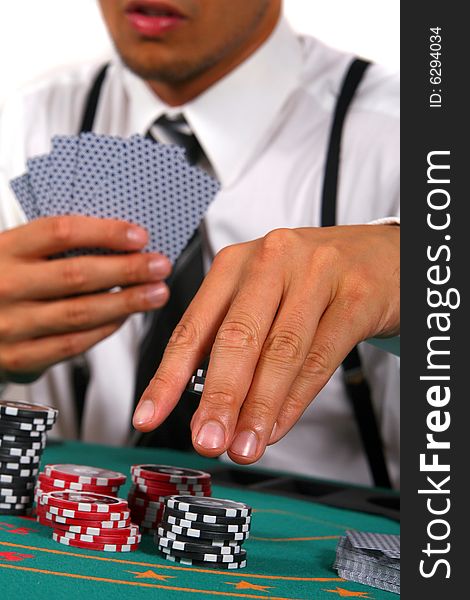 Young man playing poker. He is holding cards and chips in his hands. Isolated over white background. Young man playing poker. He is holding cards and chips in his hands. Isolated over white background.