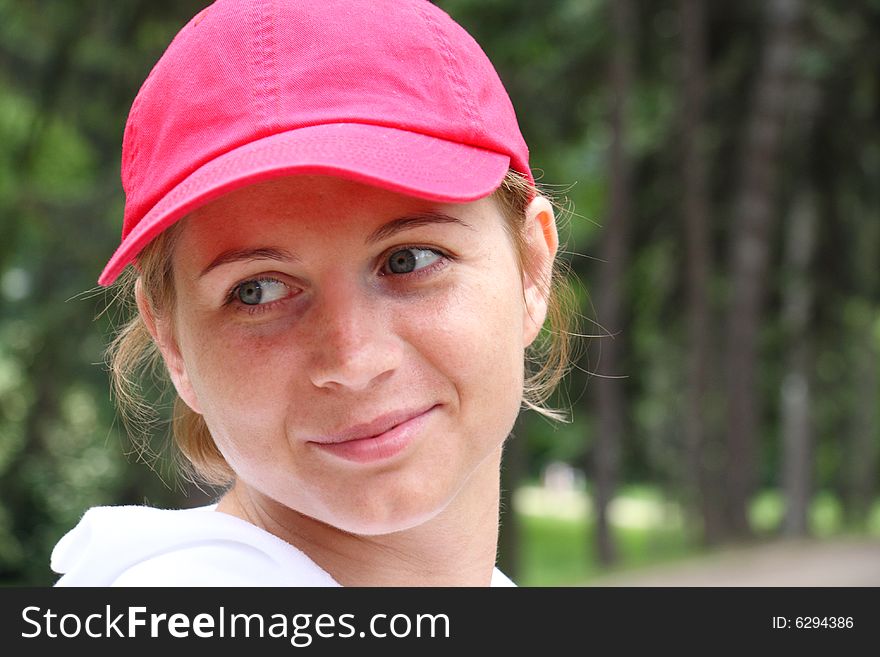 Portrait of smiling young woman in a red cap