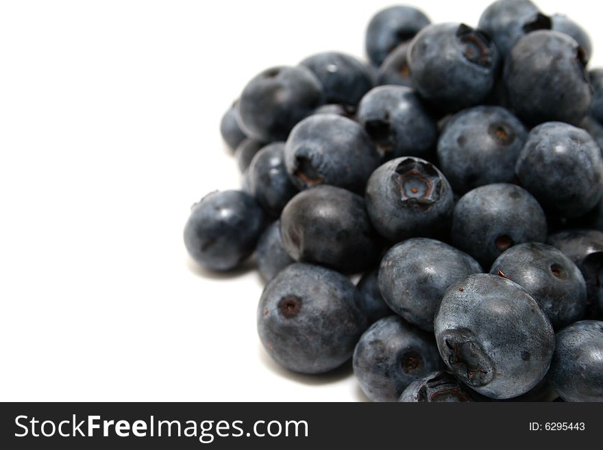 A group of blueberries isolated with a white background. A group of blueberries isolated with a white background.