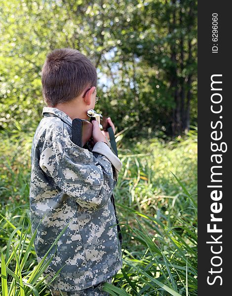 Young Boy Outside Sighting In A Rifle