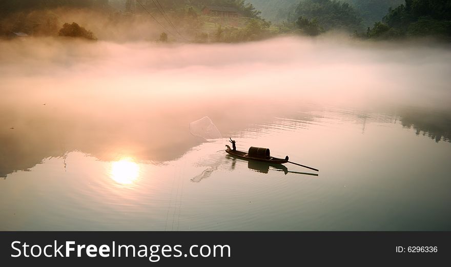 Picture is of a Foggy morning along Lost River,one fisherman and one dog in small raft. Picture is of a Foggy morning along Lost River,one fisherman and one dog in small raft.