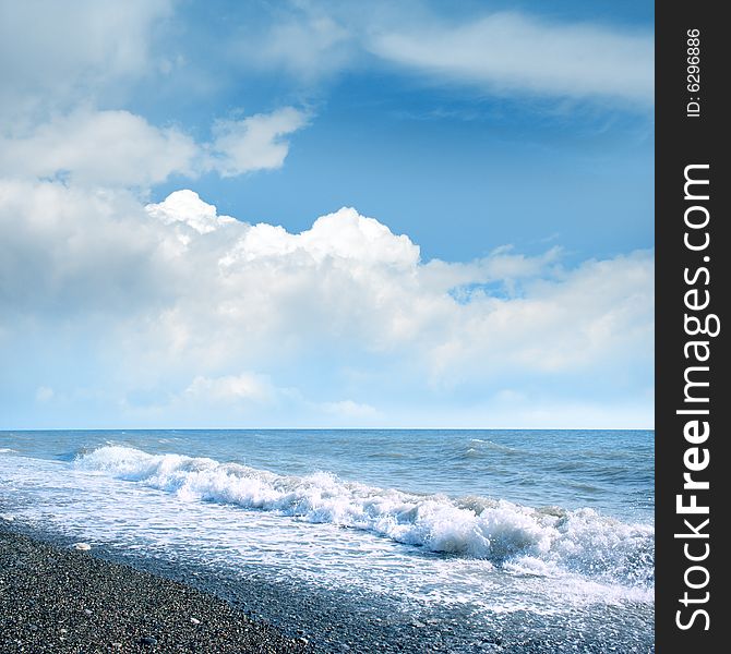 Wave on sea beach under year blue sky and cloud