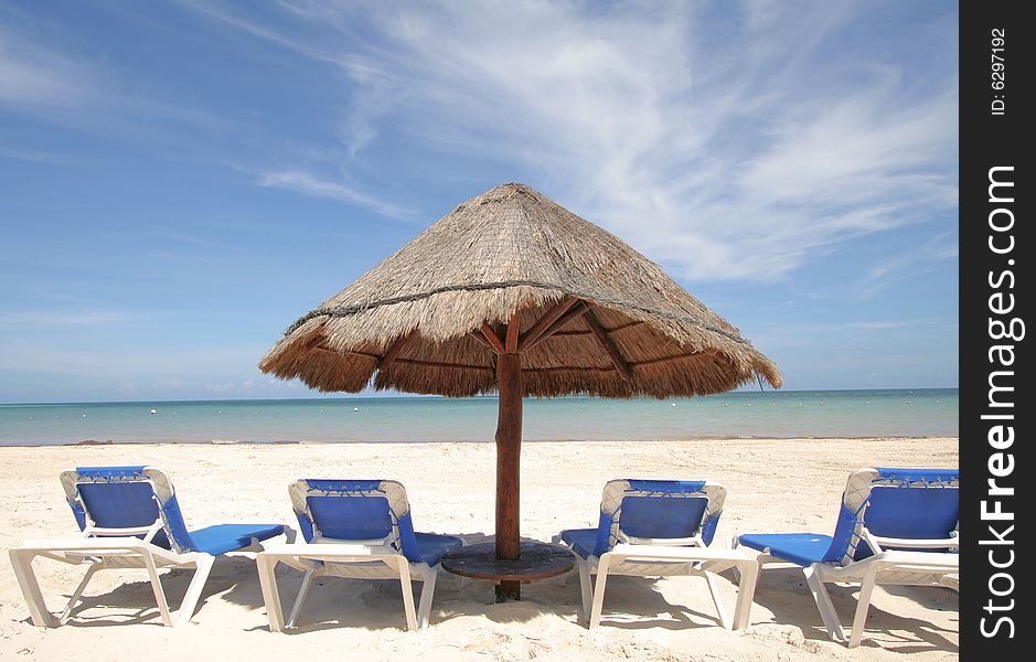 Beach scenic with lounge chairs and umbrella. Beach scenic with lounge chairs and umbrella