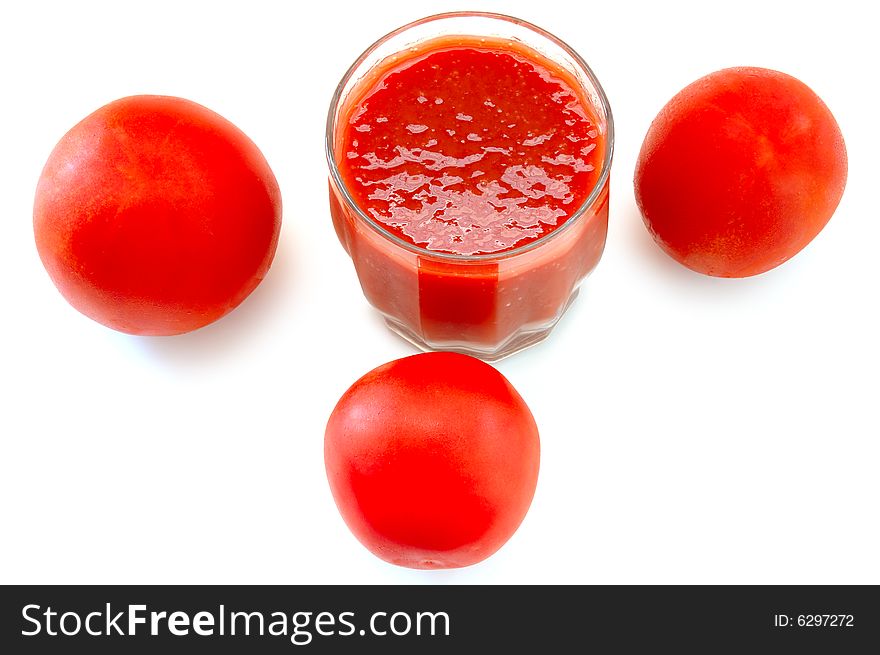 Fresh tomato juice in glass and tomatoes.