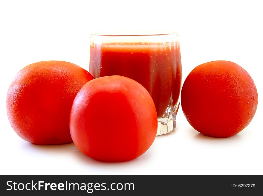 Fresh Tomato Juice In Glass And Tomatoes.