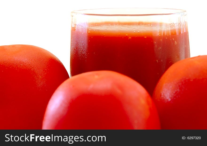 Fresh Tomato Juice In Glass And Tomatoes.