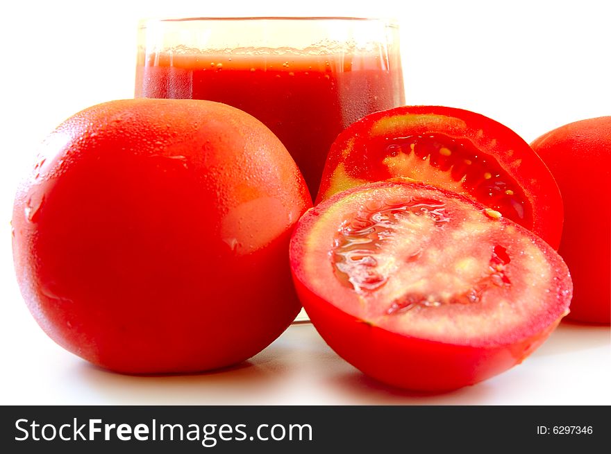 Fresh Tomato Juice In Glass And Tomatoes.