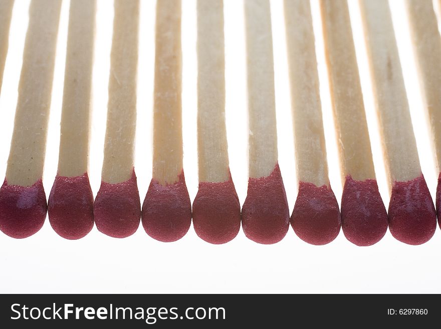 Row of matchsticks isolated on white backgroud. Row of matchsticks isolated on white backgroud