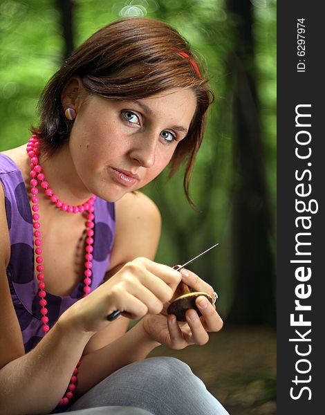 Picture of a teenager holding the mushroom in her hands. Picture of a teenager holding the mushroom in her hands