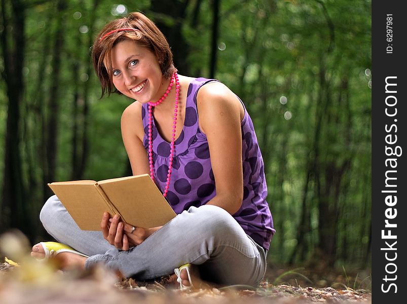 Picture of a teenager holding the bookin her hands. Picture of a teenager holding the bookin her hands