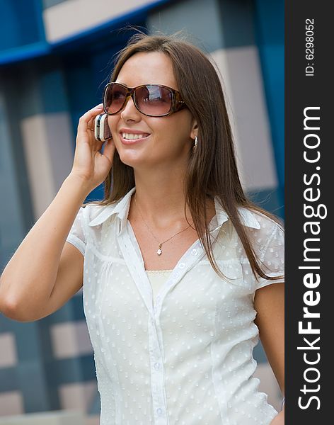 Cute smiling girl speaks on  a mobile phone. Cute smiling girl speaks on  a mobile phone
