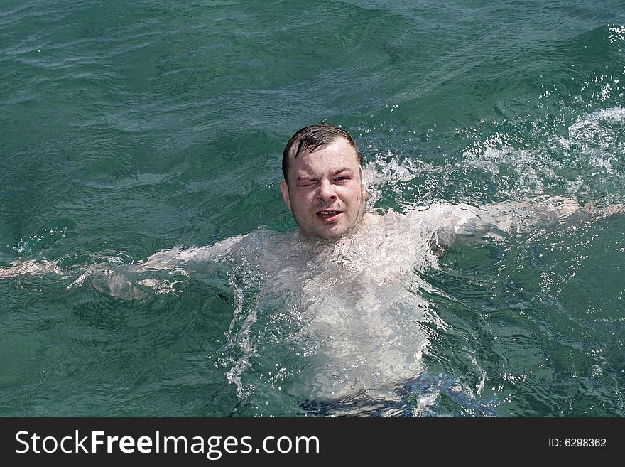 The man swims in Mediterranean Sea, Turkey. The man swims in Mediterranean Sea, Turkey