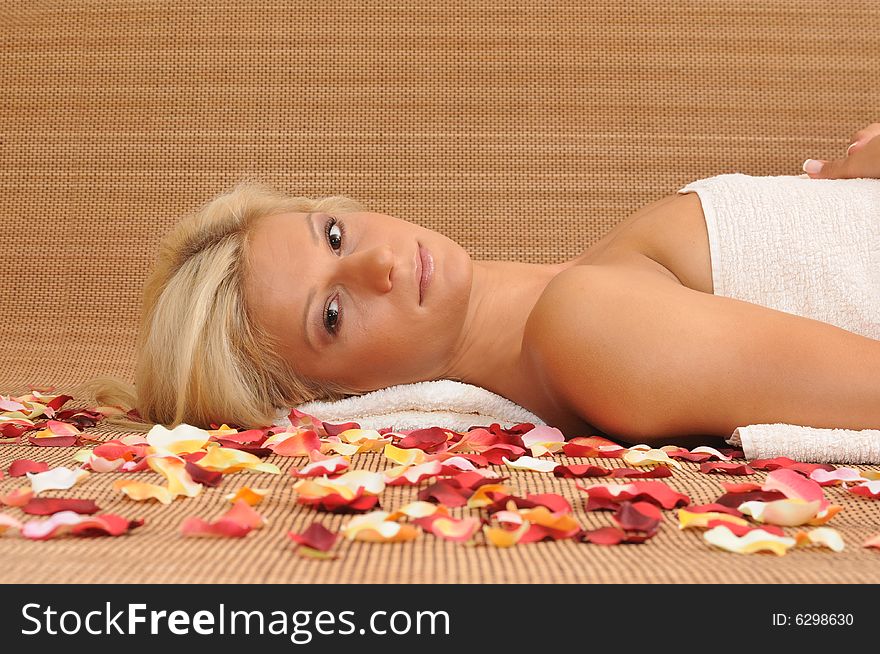 Young woman lying on a massage table,enjoying a aroma therapy. Young woman lying on a massage table,enjoying a aroma therapy.