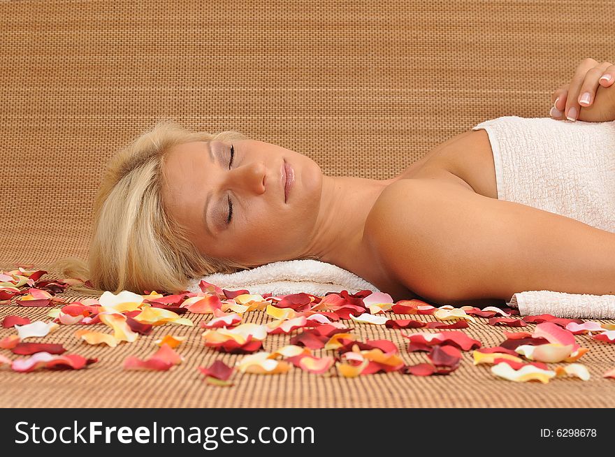 Young woman lying on a massage table,enjoying a aroma therapy. Young woman lying on a massage table,enjoying a aroma therapy.