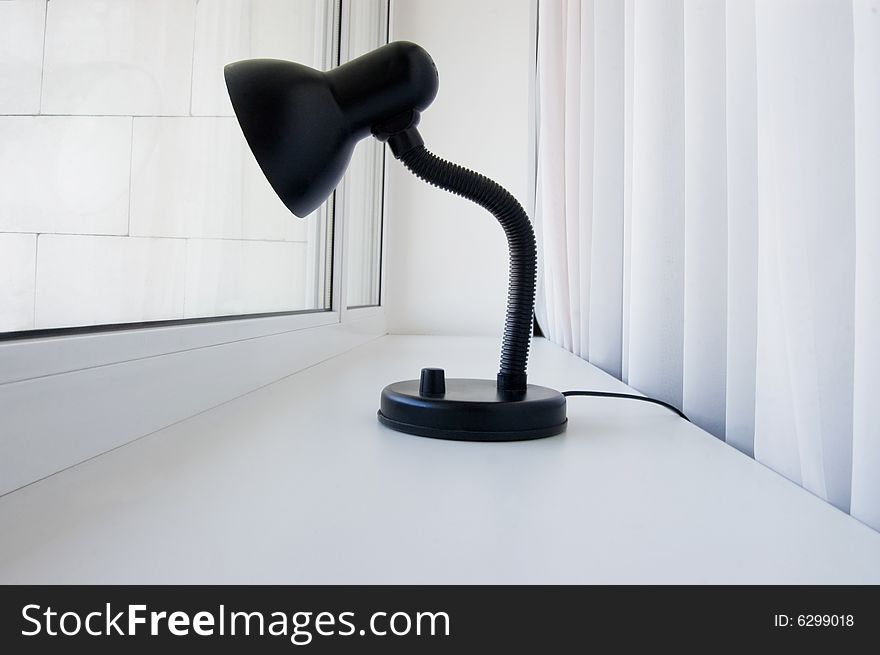 Lonely black lamp peers into the window