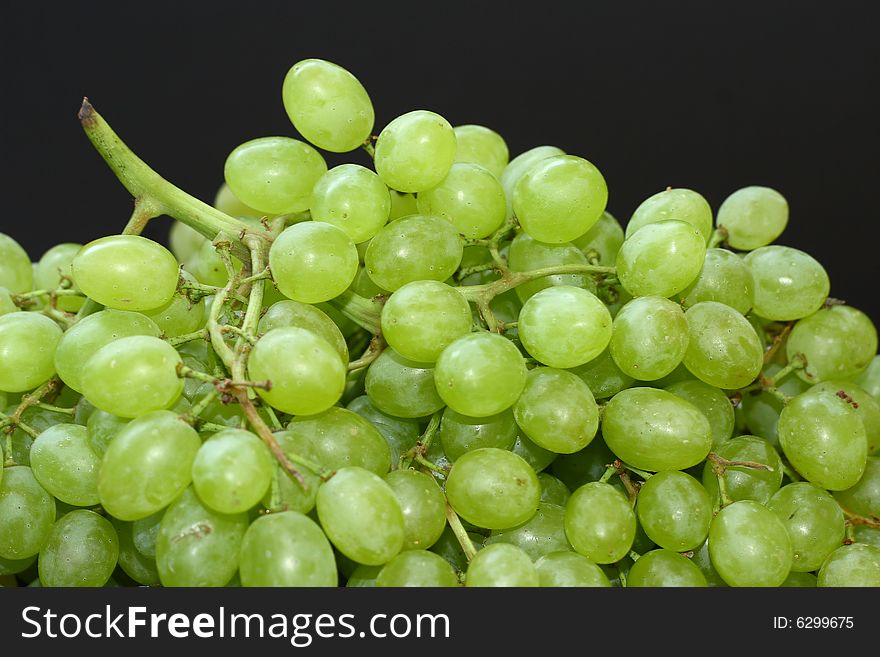 Bunch of green grapes on black background
