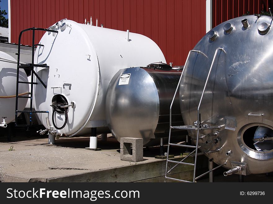A group of stainless and carbon steel tanks and vessels for winemaking