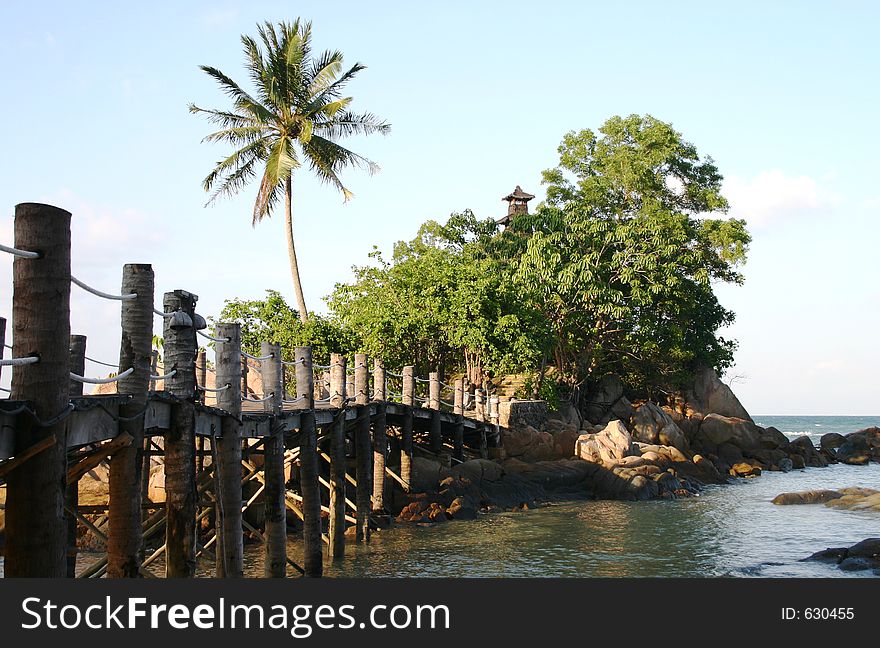 A bridge leading to a secluded island in the tropics. A bridge leading to a secluded island in the tropics