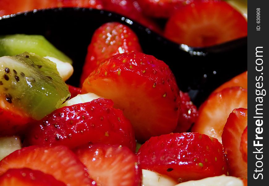 Fresh Sliced Fruit with Strawberries, Kiwi, and Banana with serving Spoon