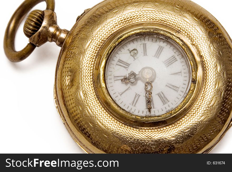 Macro shot of an aged golden pocket watch with chain. Macro shot of an aged golden pocket watch with chain.