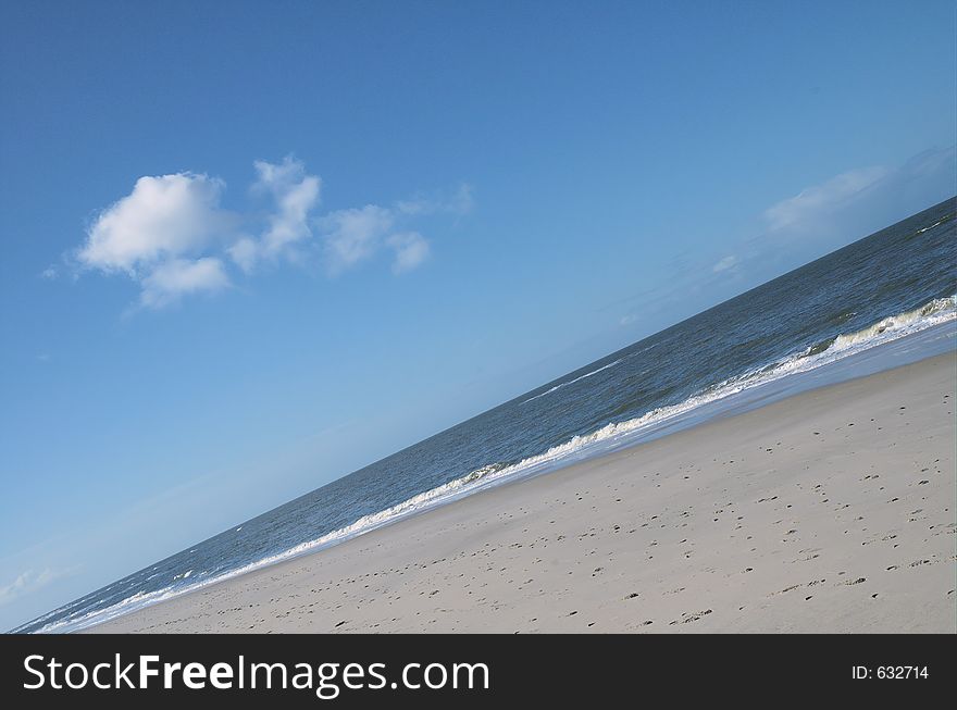 Layers: beach, wave, ocean, sky and fluffy cloud. Layers: beach, wave, ocean, sky and fluffy cloud