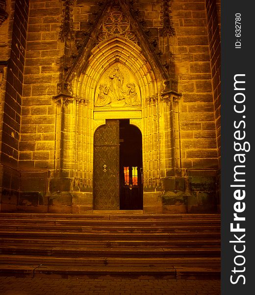 Doorway of gothic church in special lighting of sunset colors. Doorway of gothic church in special lighting of sunset colors