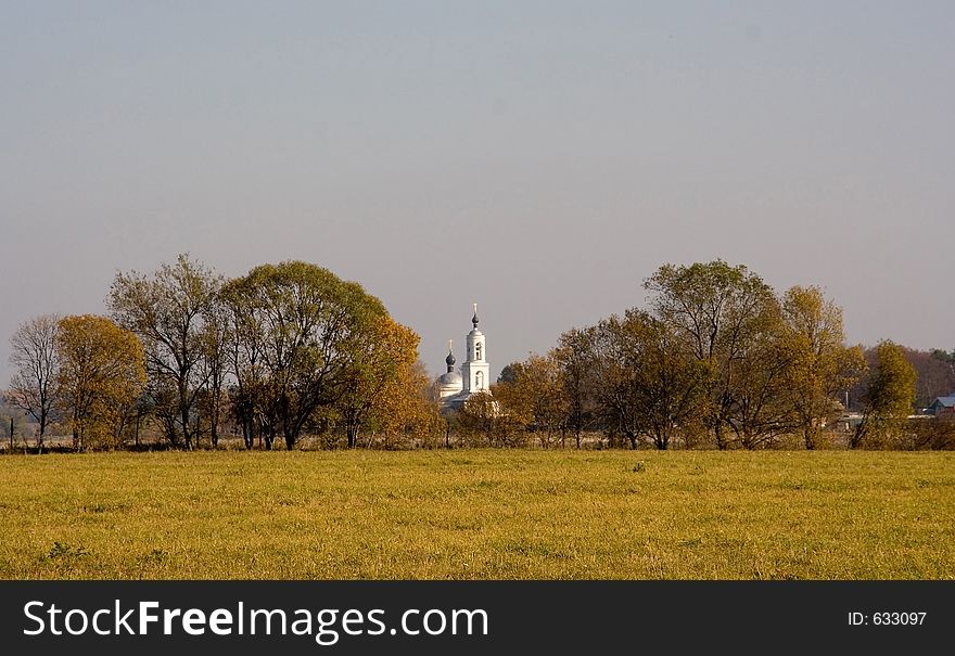 View of a church among autumn trees. View of a church among autumn trees