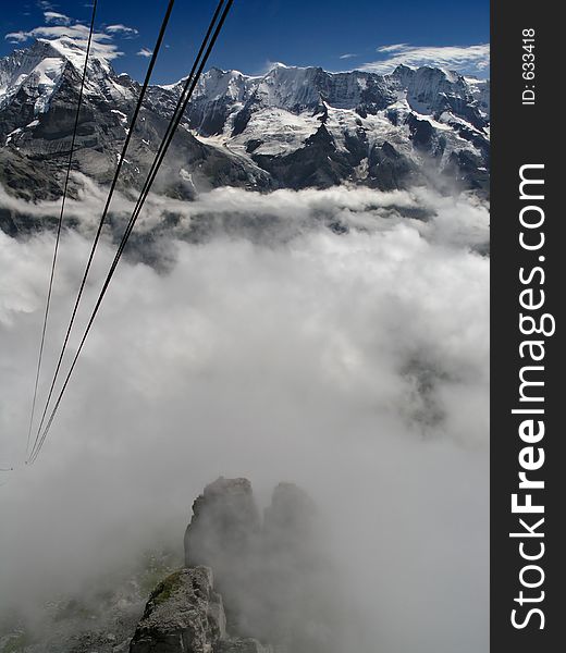 Cable descending into clouds around the Alps. Cable descending into clouds around the Alps