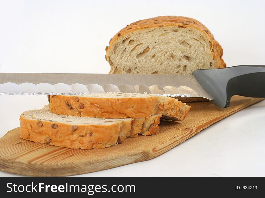 Sliced bread and a knife on white