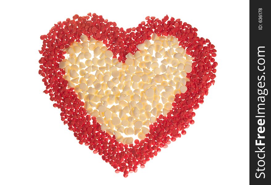 Red (cherry) and white chocolate baking chips arranged into a heart shape and isolated on white. Red (cherry) and white chocolate baking chips arranged into a heart shape and isolated on white.