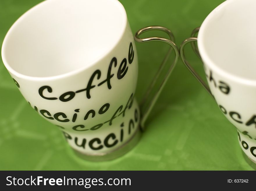 Coffee cups in green background