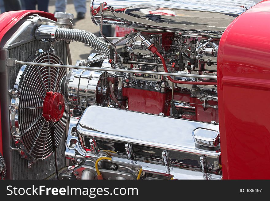 Closeup of motor in street rod in parade going through town. Closeup of motor in street rod in parade going through town