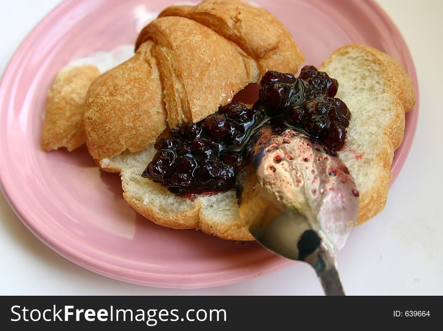 Croissants with jam and spoon