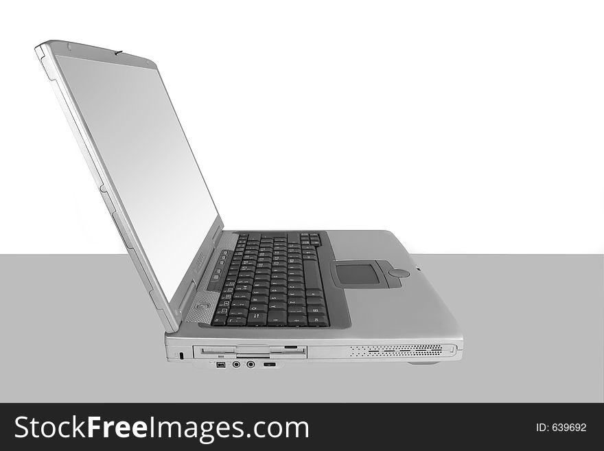 Silver laptop with a white and silver screen set against a white and grey background. Silver laptop with a white and silver screen set against a white and grey background